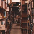 a hallway with books messily put on shelves