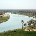 a large, winding river with green banks on either side