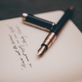a journal with a fountain pen resting on top