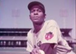 FROM ONE GREAT ARM TO ANOTHER! Satchel Paige is “pitching in” his